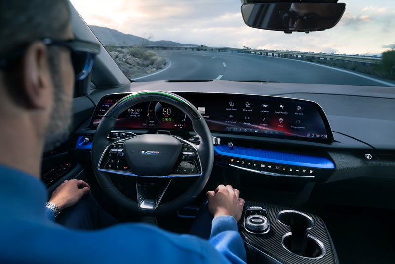 Front View of the 2026 OPTIQ-V Driving Through the Dusk Utilizing its Headlights | Huston GMC in LAKE WALES FL