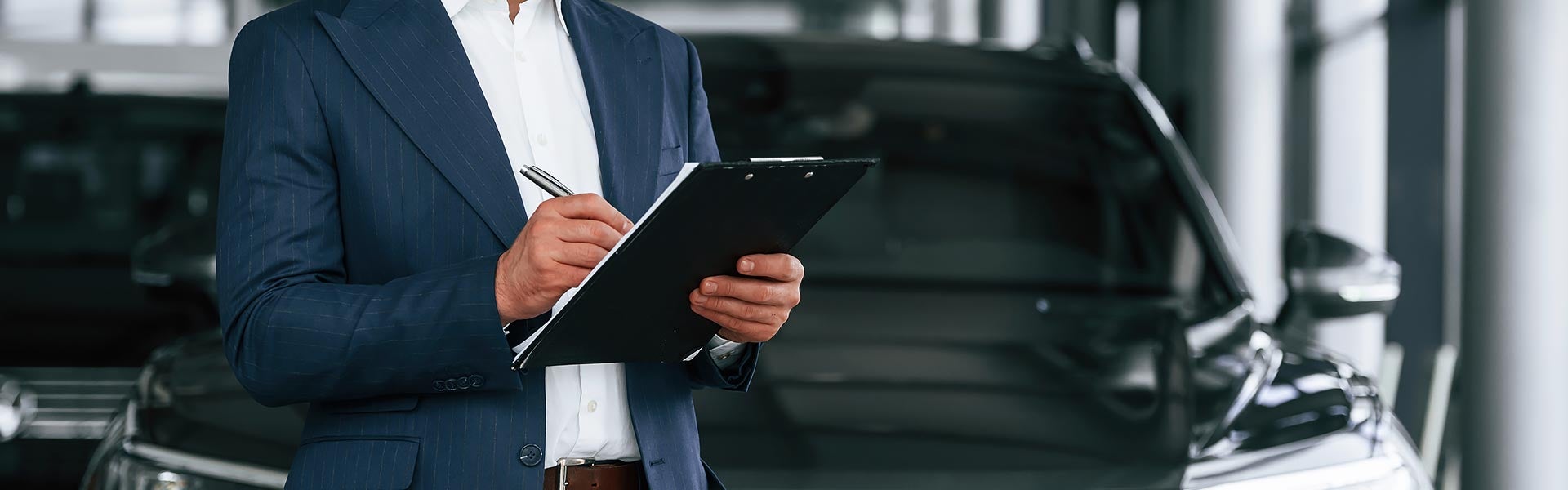 Man in a suit with a clipboard