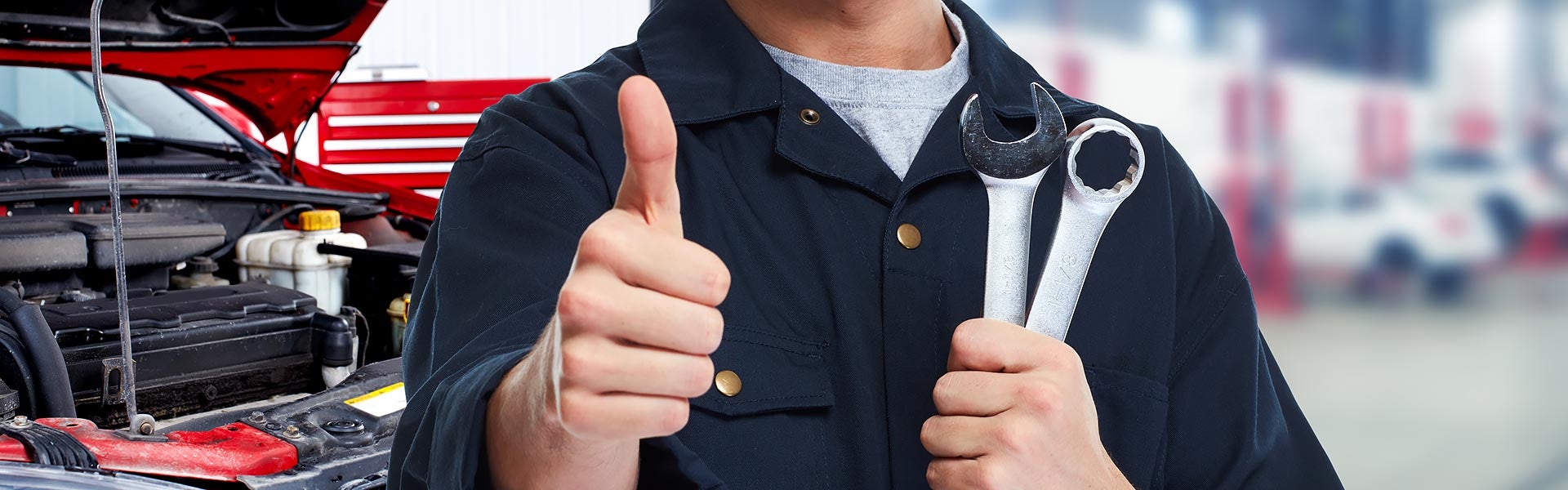 Mechanic holding a thumbs up